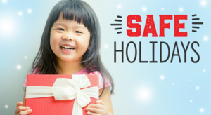 A photo of a young child holding a wrapped gift. The child is smiling. The words SAFE Holidays are next to the child. The word SAFE is in red. The word Holidays is in black.